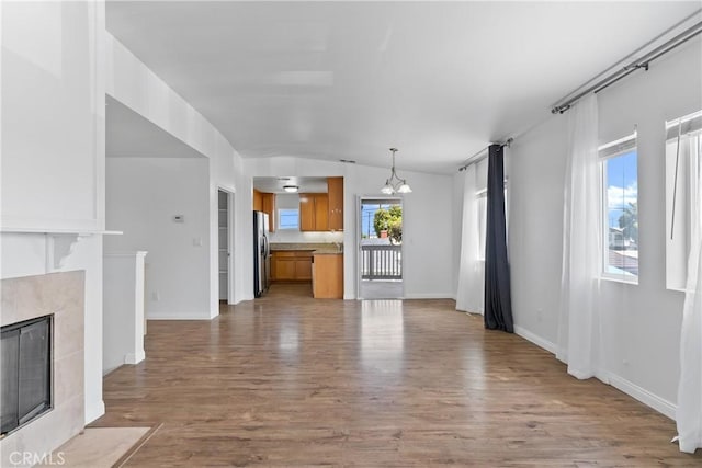 247 W 223rd St Unit D, Carson, CA 90745 - unfurnished living room featuring a chandelier, wood finished floors, and baseboards