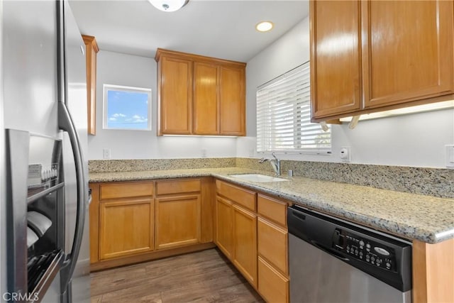 247 W 223rd St Unit D, Carson, CA 90745 - kitchen featuring appliances with stainless steel finishes, a sink, wood finished floors, light stone counters, and recessed lighting