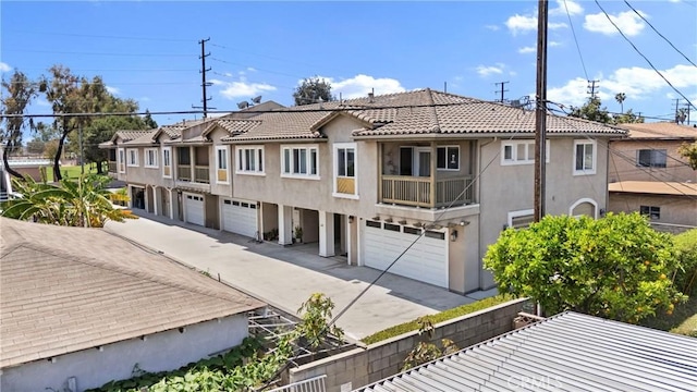 247 W 223rd St Unit D, Carson, CA 90745 - view of front of house with a garage, a tiled roof, stucco siding, and driveway