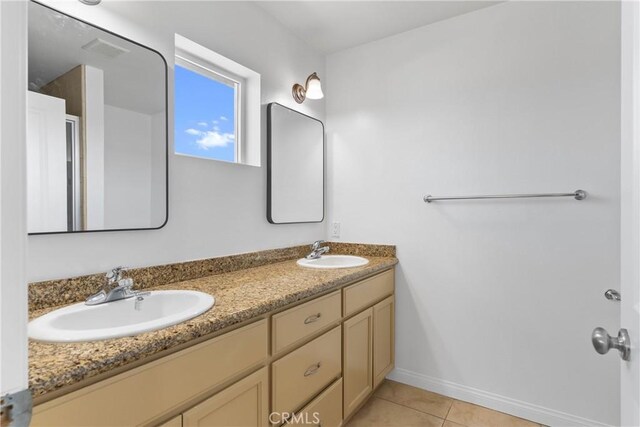 247 W 223rd St Unit D, Carson, CA 90745 - bathroom featuring tile patterned floors, double vanity, and baseboards