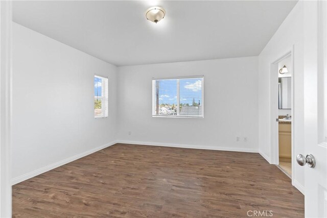 247 W 223rd St Unit D, Carson, CA 90745 - unfurnished bedroom featuring wood finished floors, baseboards, and connected bathroom