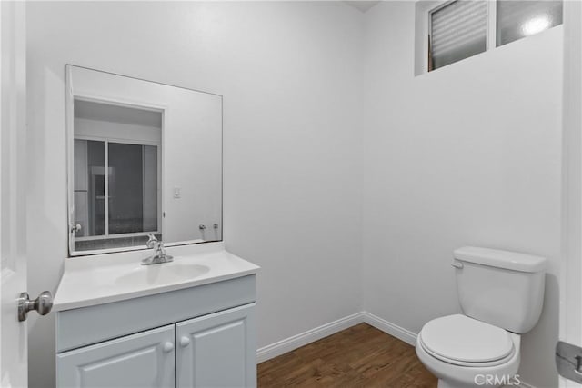 247 W 223rd St Unit D, Carson, CA 90745 - bathroom with toilet, wood finished floors, vanity, and baseboards