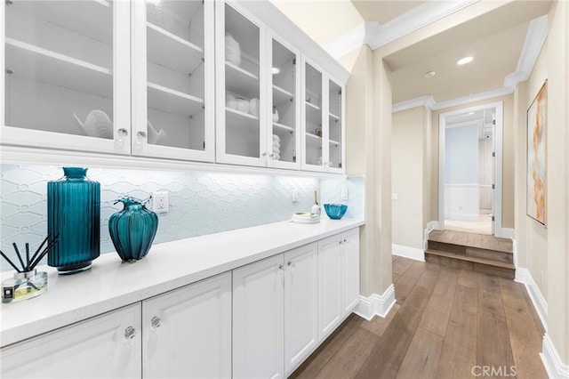 123 Calderon, Irvine, CA 92618 - bar featuring tasteful backsplash, crown molding, baseboards, recessed lighting, and dark wood-type flooring