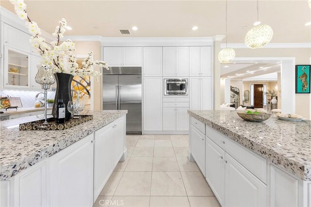 123 Calderon, Irvine, CA 92618 - kitchen featuring built in appliances, visible vents, ornamental molding, and white cabinetry