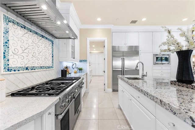 123 Calderon, Irvine, CA 92618 - kitchen with built in appliances, white cabinets, custom range hood, and a sink