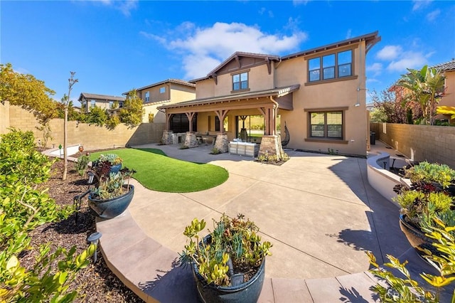 123 Calderon, Irvine, CA 92618 - back of property featuring a fenced backyard, stucco siding, and a patio area