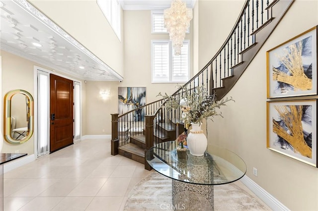 123 Calderon, Irvine, CA 92618 - entryway featuring baseboards, an inviting chandelier, a high ceiling, tile patterned flooring, and stairs