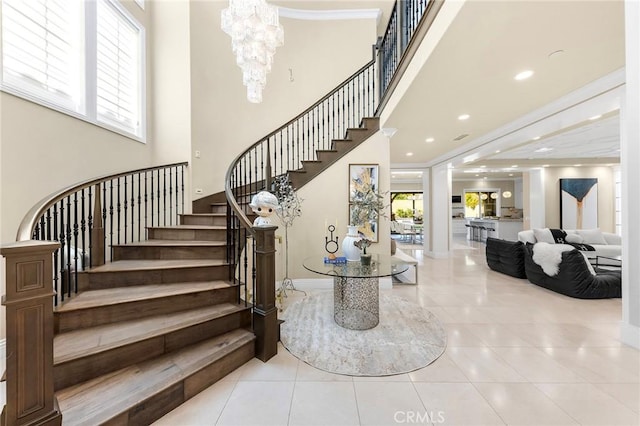 123 Calderon, Irvine, CA 92618 - staircase featuring a chandelier, tile patterned flooring, baseboards, and a towering ceiling
