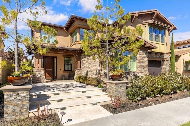 123 Calderon, Irvine, CA 92618 - view of front facade featuring a porch, stone siding, and stucco siding