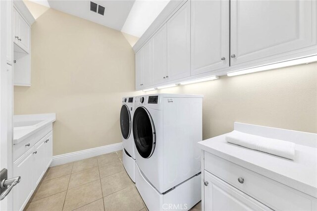 123 Calderon, Irvine, CA 92618 - laundry area with visible vents, light tile patterned floors, washing machine and clothes dryer, baseboards, and cabinet space