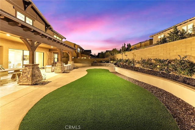 123 Calderon, Irvine, CA 92618 - yard at dusk with a patio and a fenced backyard