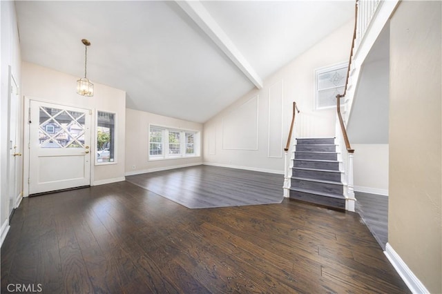 unfurnished living room with a chandelier, hardwood / wood-style floors, stairs, and baseboards