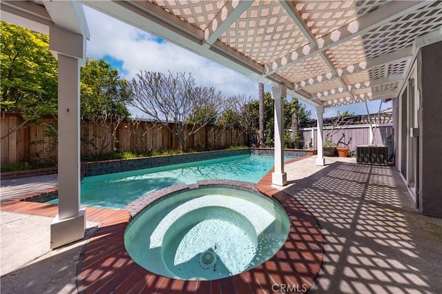 view of swimming pool with a pool with connected hot tub and a fenced backyard