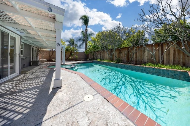view of pool featuring a fenced backyard, a patio area, and a pool with connected hot tub