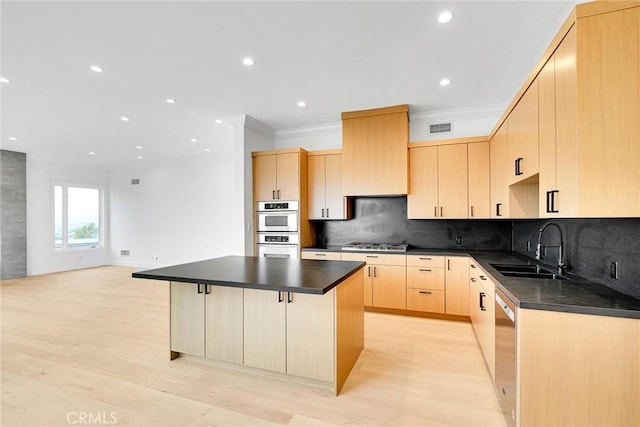 10050 Olivia Ter, Sun Valley, CA 91352 - kitchen with light brown cabinets, dark countertops, a sink, stainless steel appliances, and visible vents
