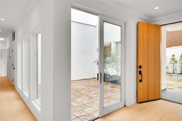 10050 Olivia Ter, Sun Valley, CA 91352 - doorway to outside featuring light wood finished floors, visible vents, recessed lighting, and crown molding