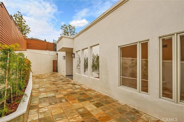 10050 Olivia Ter, Sun Valley, CA 91352 - view of side of property featuring fence, a patio area, and stucco siding