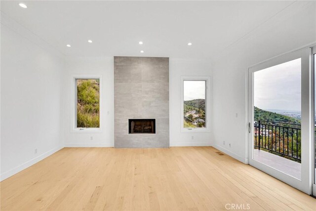 10050 Olivia Ter, Sun Valley, CA 91352 - unfurnished living room with recessed lighting, light wood-type flooring, a fireplace, and baseboards