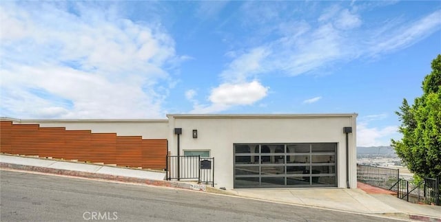 10050 Olivia Ter, Sun Valley, CA 91352 - view of side of home with stucco siding, fence, concrete driveway, and a garage