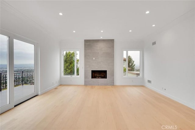 10050 Olivia Ter, Sun Valley, CA 91352 - unfurnished living room with baseboards, ornamental molding, light wood finished floors, and recessed lighting