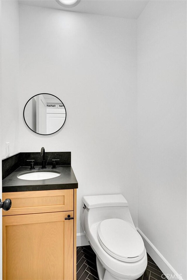 10050 Olivia Ter, Sun Valley, CA 91352 - half bath with baseboards, tile patterned flooring, vanity, and toilet