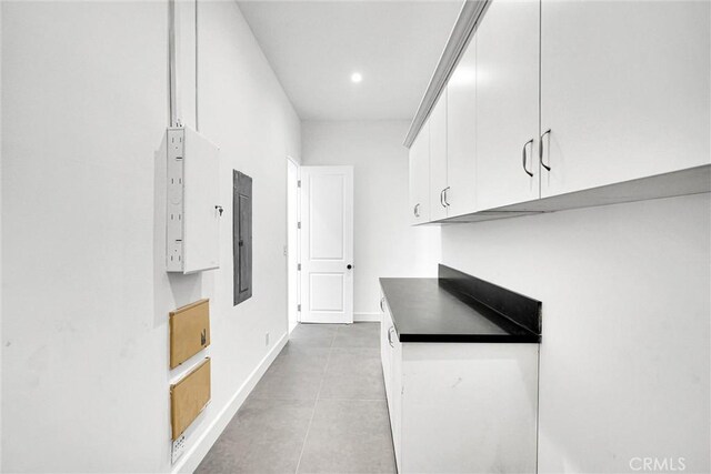 10050 Olivia Ter, Sun Valley, CA 91352 - kitchen featuring dark countertops, baseboards, white cabinetry, and light tile patterned flooring
