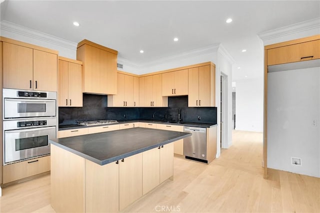 10050 Olivia Ter, Sun Valley, CA 91352 - kitchen with light wood finished floors, light brown cabinetry, stainless steel appliances, dark countertops, and a sink