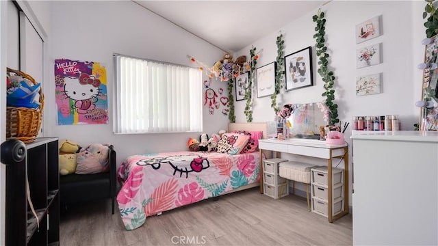 bedroom featuring light wood finished floors and a closet