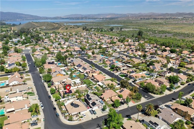 aerial view featuring a water and mountain view and a residential view