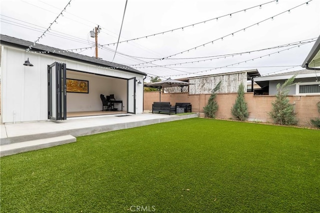 view of yard with fence and a patio