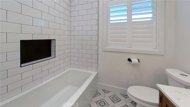 bathroom featuring baseboards, toilet, and vanity