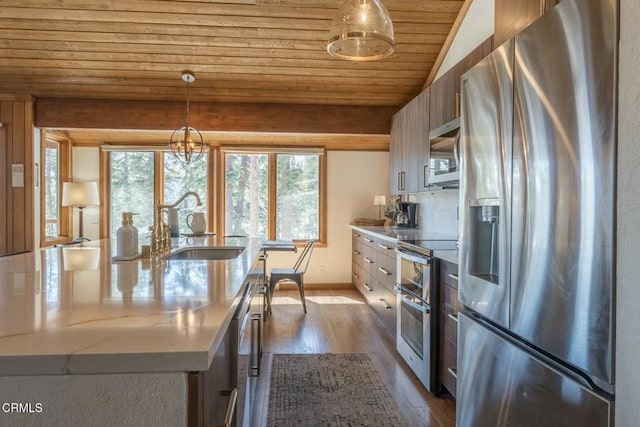435 Lakeview Blvd Unit 116, Mammoth Lakes, CA 93546 - kitchen featuring stainless steel appliances, wooden ceiling, dark wood-style floors, a kitchen island with sink, and hanging light fixtures