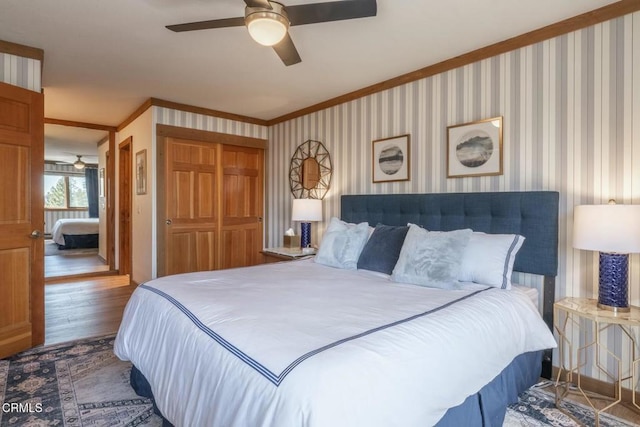 435 Lakeview Blvd Unit 116, Mammoth Lakes, CA 93546 - bedroom with ornamental molding, wood finished floors, wallpapered walls, a closet, and a ceiling fan