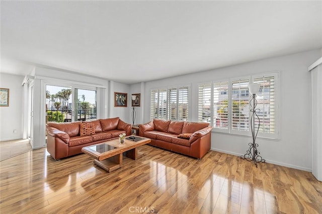 living room featuring light wood-style flooring and baseboards