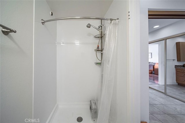 bathroom featuring a shower stall and tile patterned floors