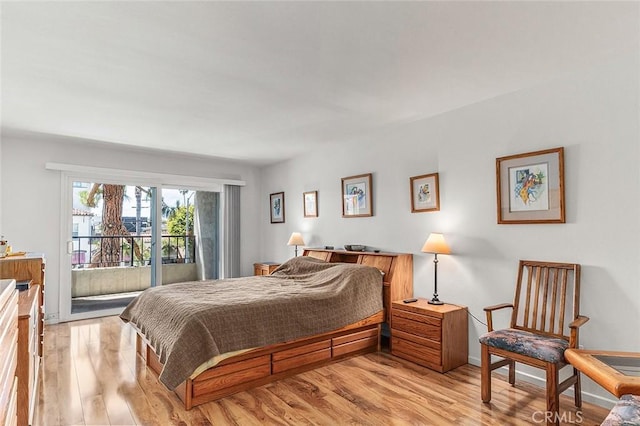 bedroom with light wood-type flooring and access to outside