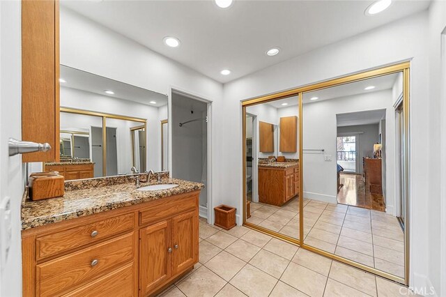 full bathroom featuring tile patterned floors, baseboards, vanity, and recessed lighting