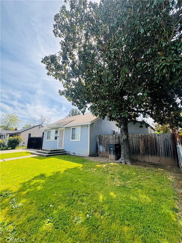 exterior space with a lawn and fence