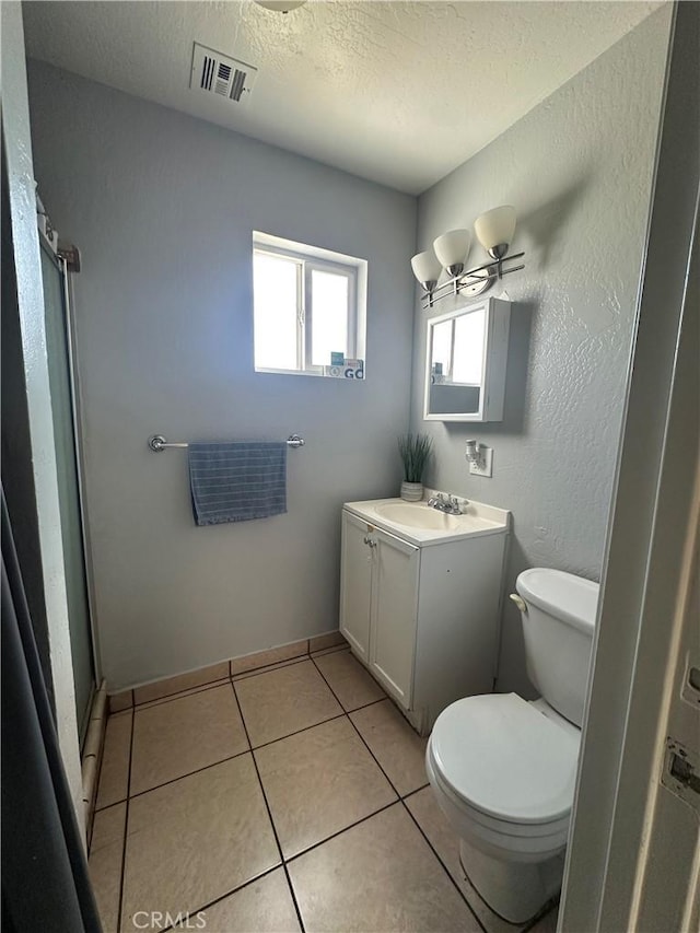 full bathroom featuring a textured ceiling, toilet, visible vents, tile patterned flooring, and vanity