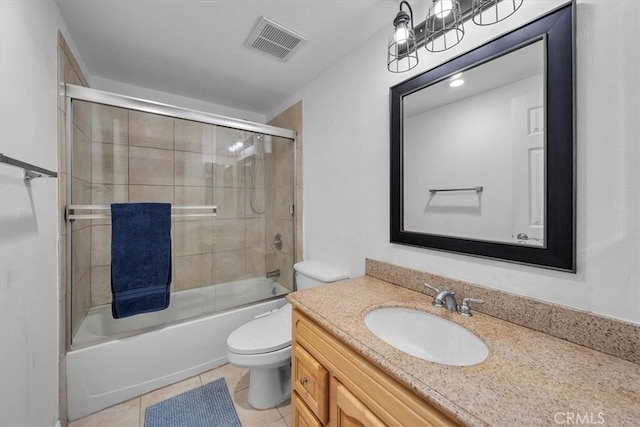 bathroom with tile patterned flooring, visible vents, toilet, vanity, and combined bath / shower with glass door