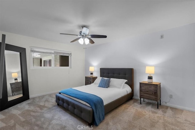 carpeted bedroom with a ceiling fan and baseboards