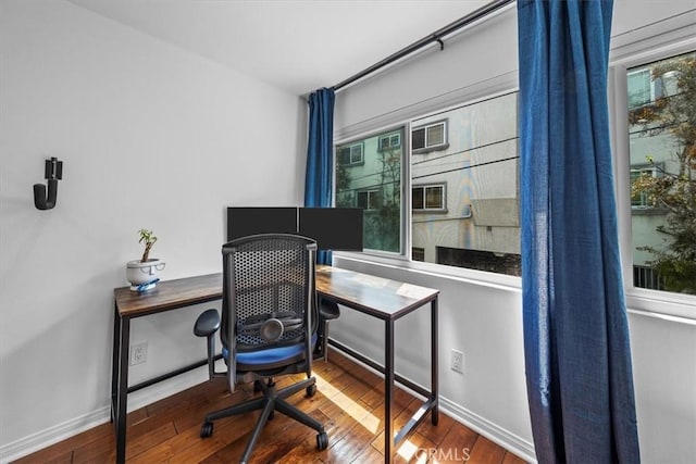 home office with baseboards, hardwood / wood-style floors, and plenty of natural light