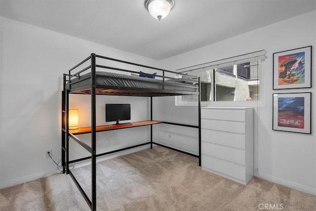 unfurnished bedroom featuring baseboards and carpet flooring