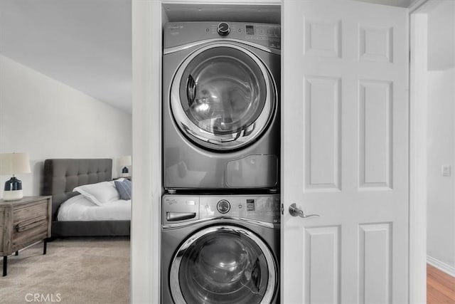 laundry area with stacked washer and dryer