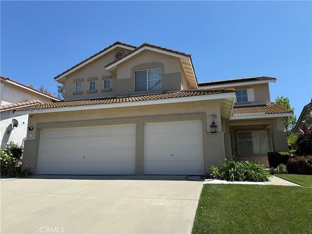 view of front facade featuring a front lawn, stucco siding, driveway, and a tiled roof