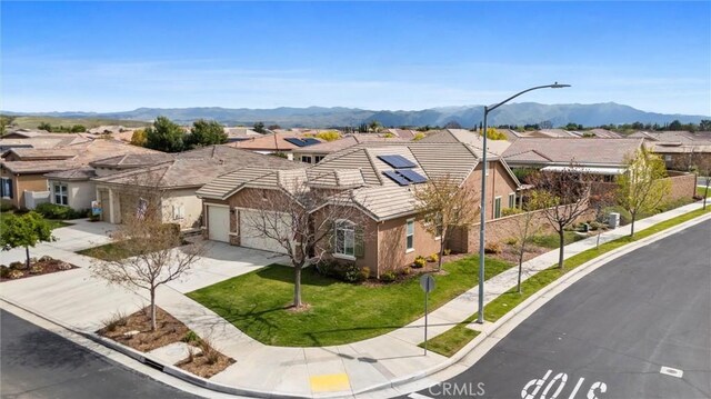 6207 Shelburne Dr, Bakersfield, CA 93306 - view of front facade with a residential view, a tiled roof, driveway, and stucco siding