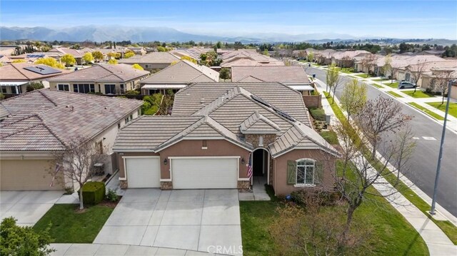 6207 Shelburne Dr, Bakersfield, CA 93306 - view of front of home with a residential view, a garage, a tile roof, and stucco siding