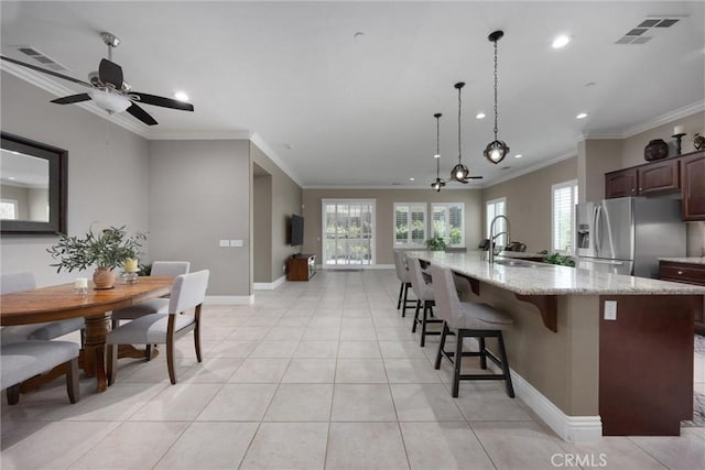 6207 Shelburne Dr, Bakersfield, CA 93306 - kitchen featuring stainless steel fridge with ice dispenser, crown molding, recessed lighting, a breakfast bar, and baseboards