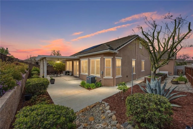 6207 Shelburne Dr, Bakersfield, CA 93306 - view of front of home with a patio area, a fenced backyard, stucco siding, and central AC unit