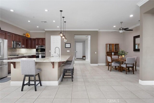 6207 Shelburne Dr, Bakersfield, CA 93306 - kitchen with appliances with stainless steel finishes, recessed lighting, a sink, a ceiling fan, and ornamental molding